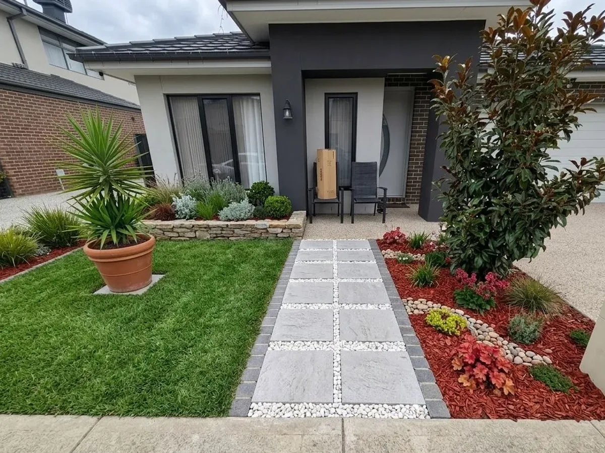Front entry path of large-format pavers set in white pebbles between lawn and garden beds