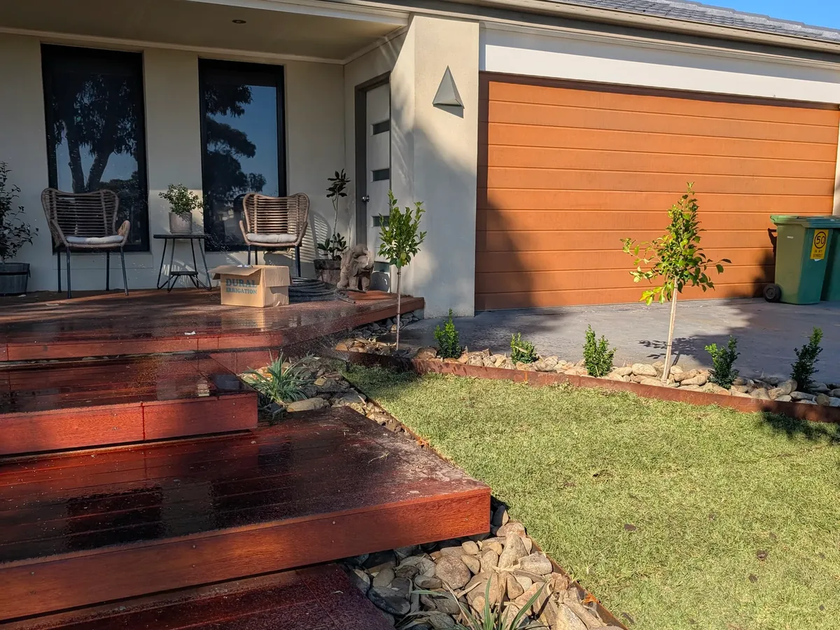 New natural lawn beside merbau steps at the front of a home