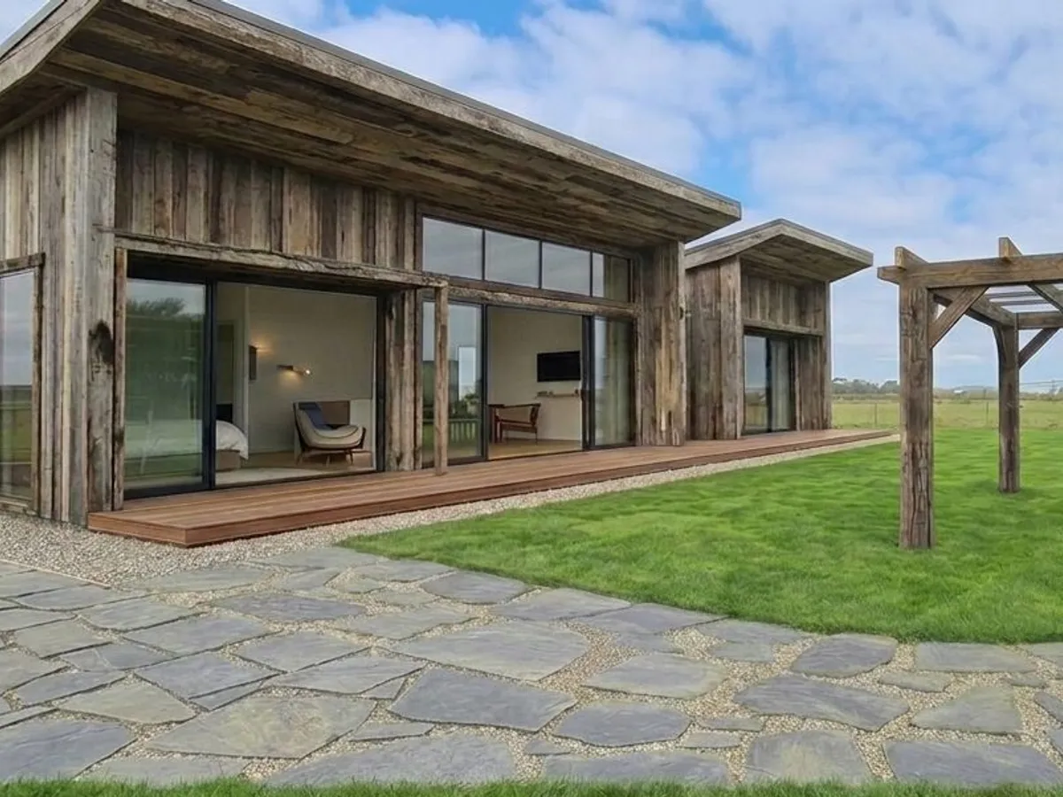 Stone paver patio beneath a timber pergola