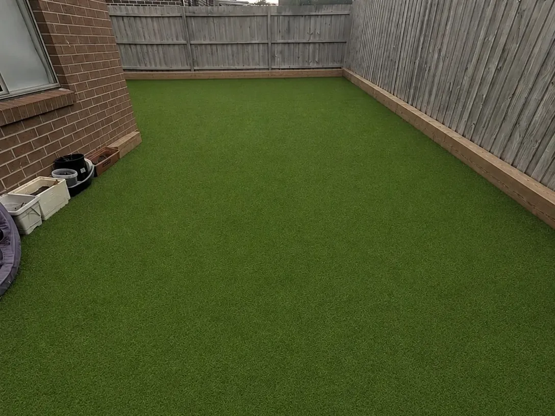 Synthetic turf filling a fenced side yard wall to wall